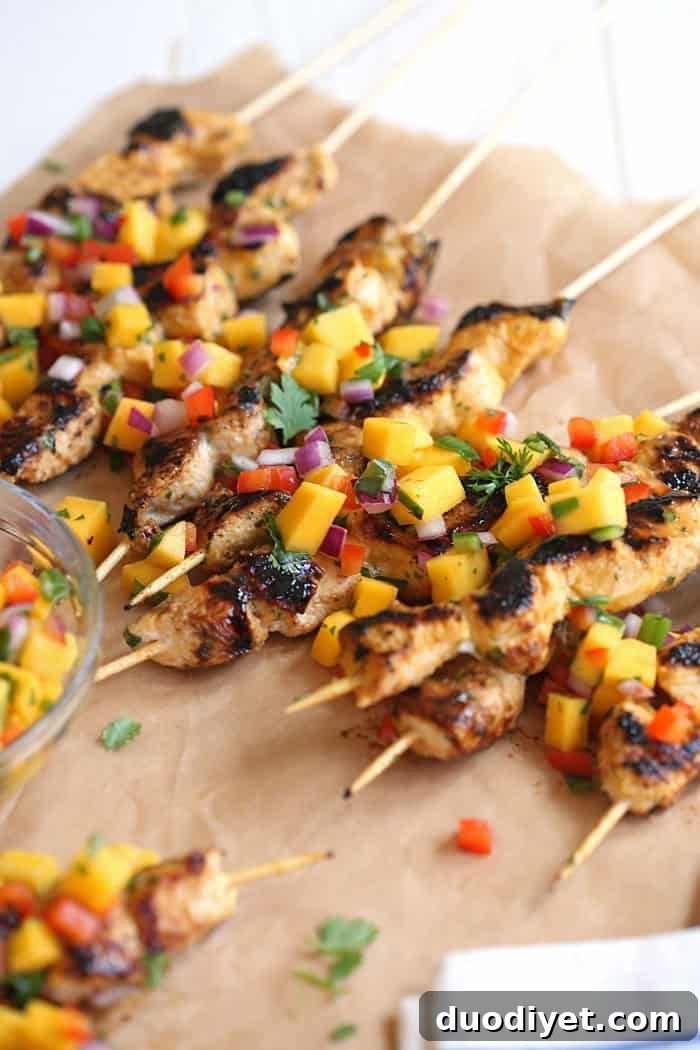 Grilled Mango Sriracha Chicken Skewers 4 Mango salsa topping the skewers