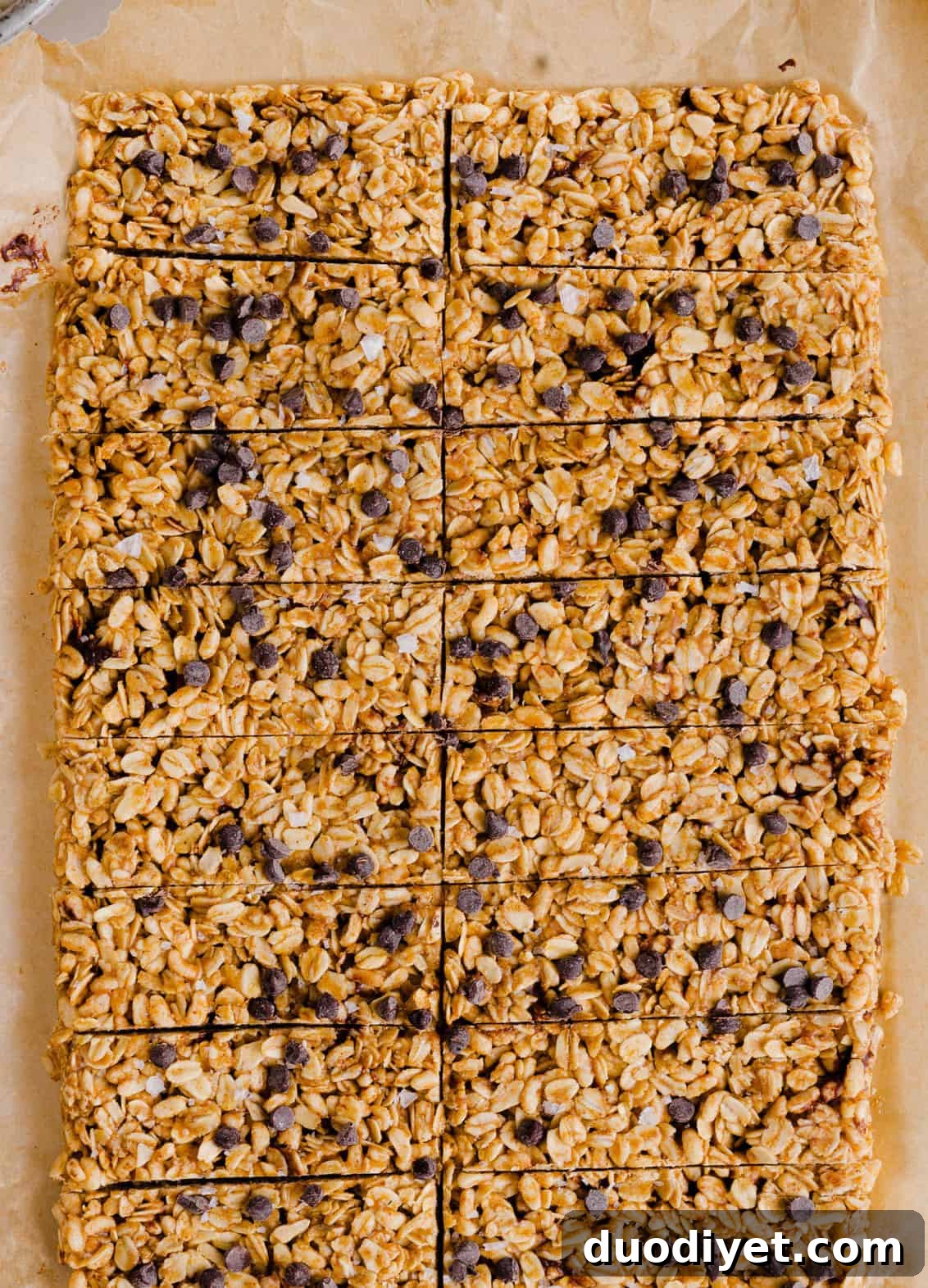 No-Bake Almond Butter Granola Bars Recipe 6 Sliced almond butter granola bars on parchment