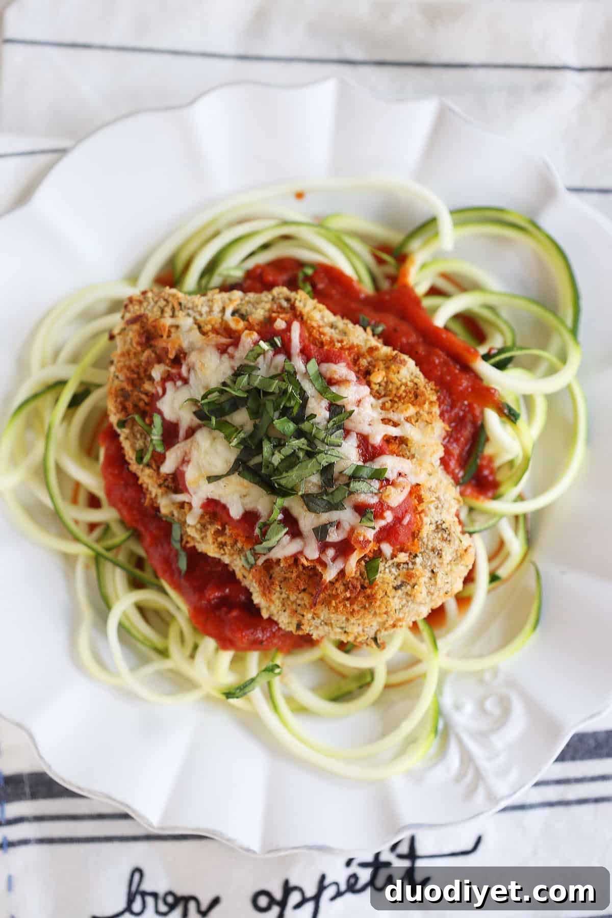 Crispy Baked Chicken Parmesan with Zucchini Noodles 4 Crispy baked chicken topped with marinara and mozzarella
