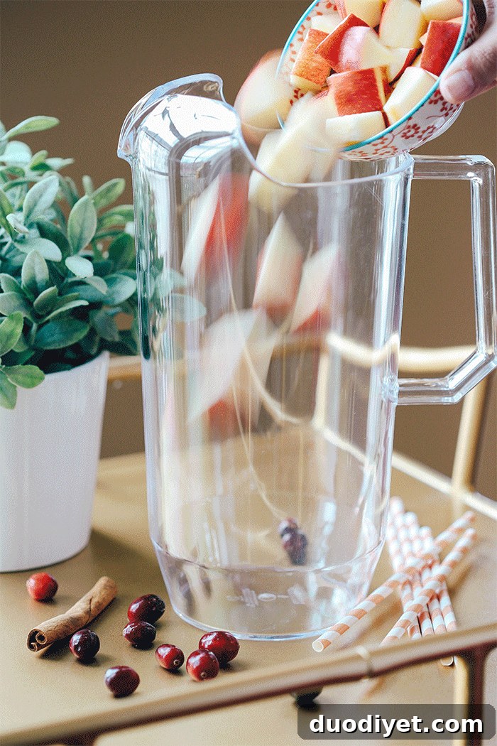 Close-up of a glass of Fall Harvest Sangria with fruit and cinnamon