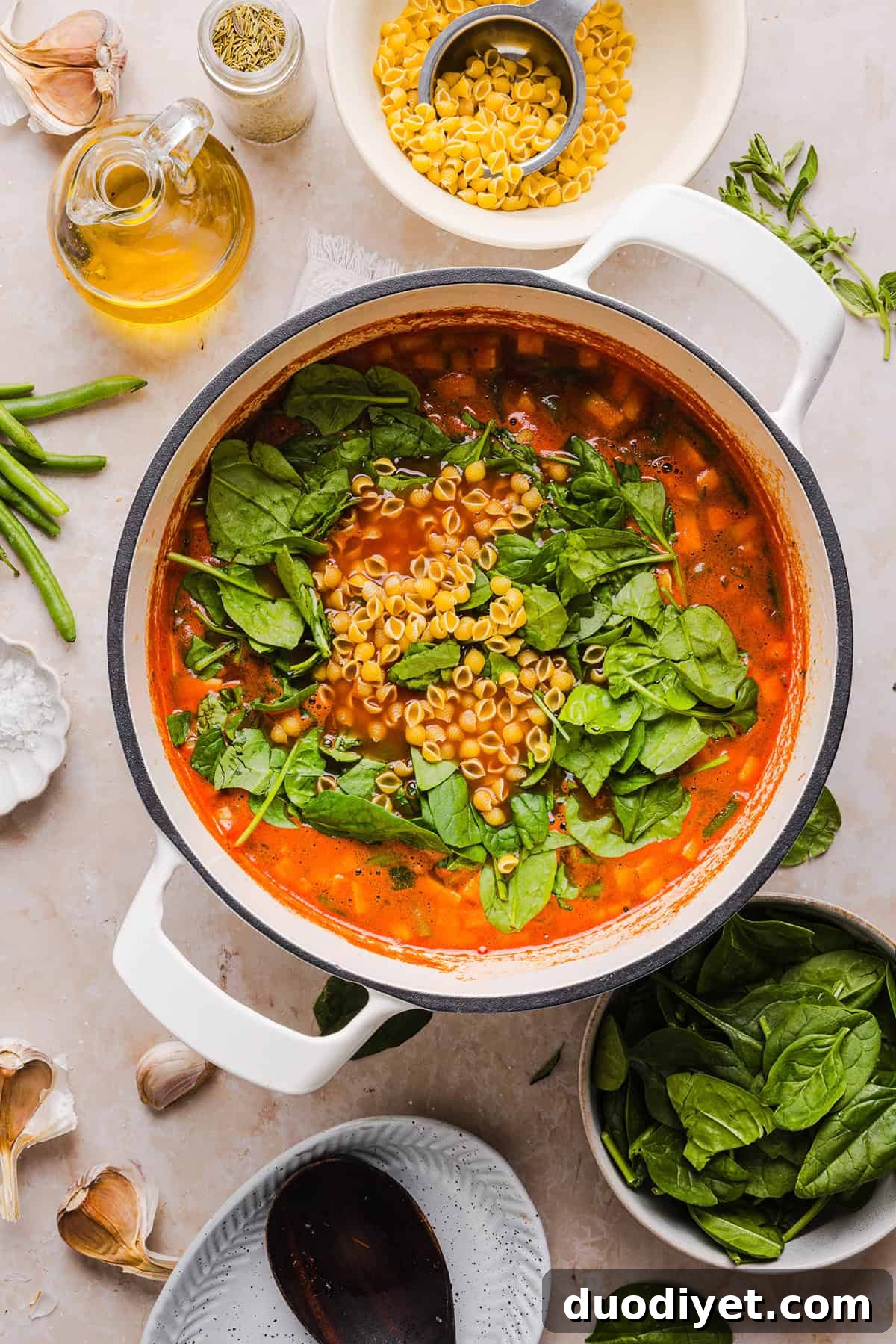 Easy and delicious Olive Garden Minestrone Soup loaded with fresh veggies, leafy greens and simmered in the most flavorful broth! Easily made in one pot for a cozy weeknight dinner the whole family will love!