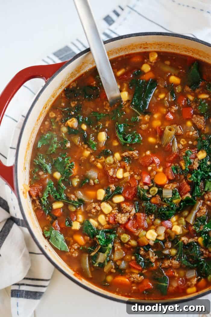 One pot spicy sausage and kale soup with vegetables