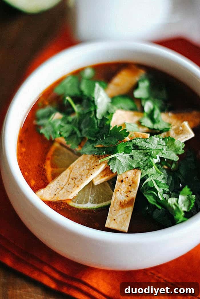 Chipotle chicken tortilla soup topped with tortilla strips