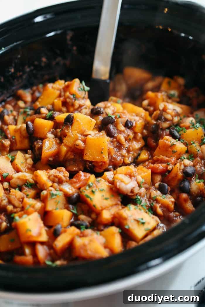 Butternut squash and farro chili in a serving bowl