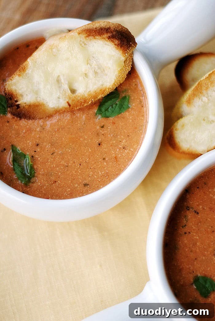 Creamy tomato basil soup garnished with basil leaves