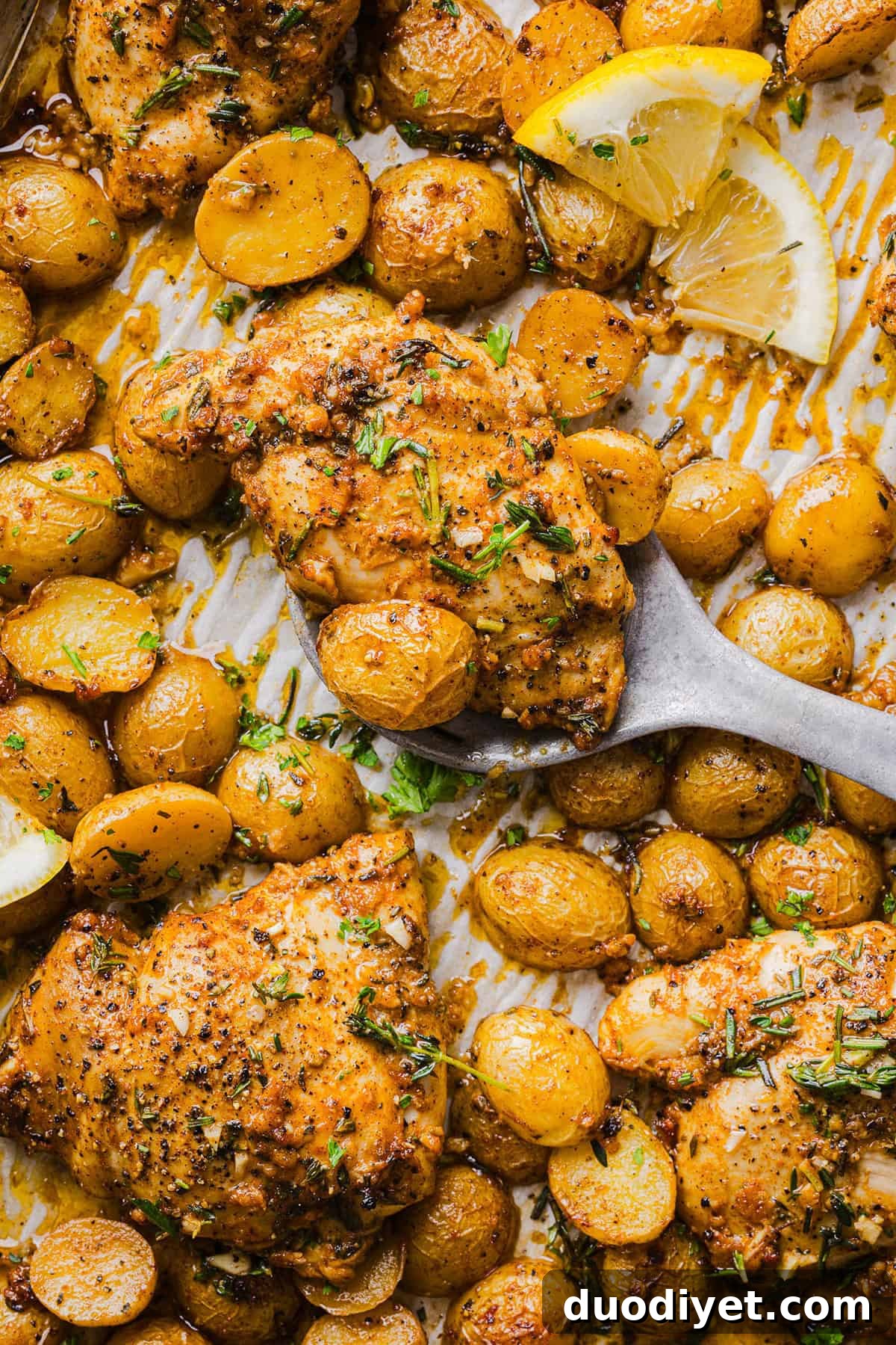 Crispy roasted potatoes and lemon-herb chicken on a sheet pan.