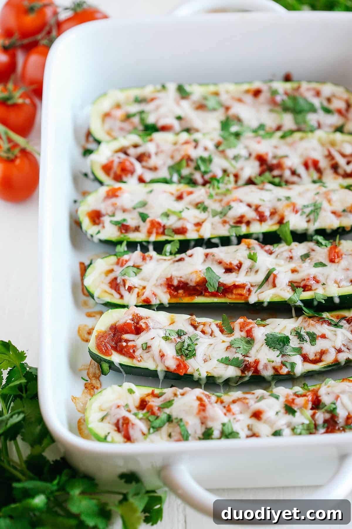 These Enchilada Stuffed Zucchini Boats are super flavorful, easy to make and are a much healthier alternative to your favorite dish!
