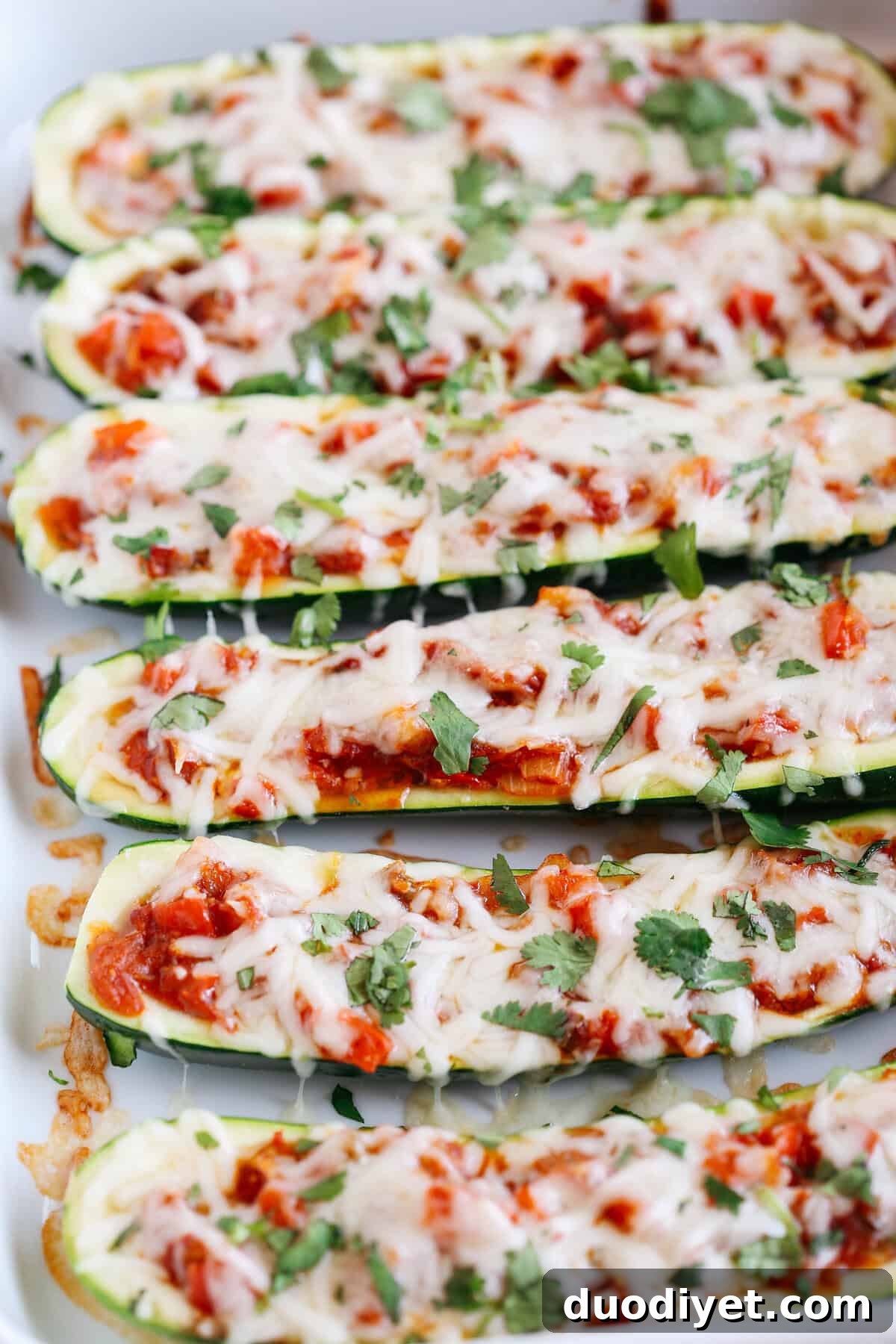 These Enchilada Stuffed Zucchini Boats are super flavorful, easy to make and are a much healthier alternative to your favorite dish!