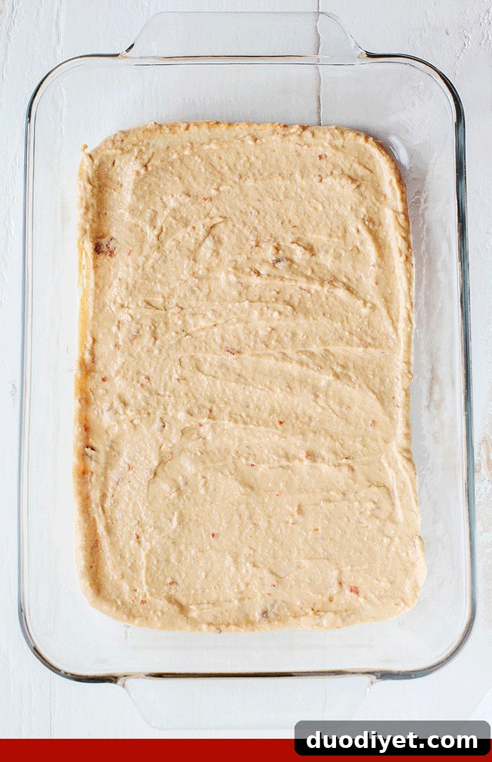 Healthier 7 Layer Spicy Taco Dip made with Greek yogurt, hummus, fresh guacamole, chunky salsa, homemade taco seasoning and all the fun toppings! Super easy to make and always a crowdpleaser!