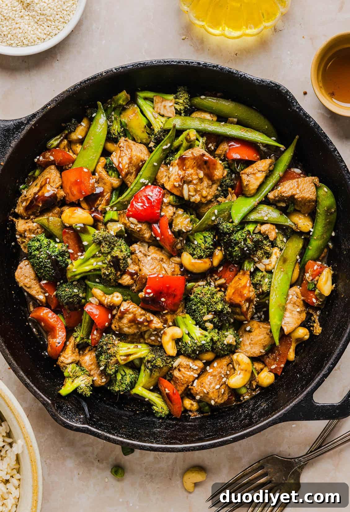 This Healthy Cashew Chicken Stir Fry is the perfect weeknight meal that is quick and easy to make, full of fresh veggies and tossed together in a delicious homemade peanut sauce!