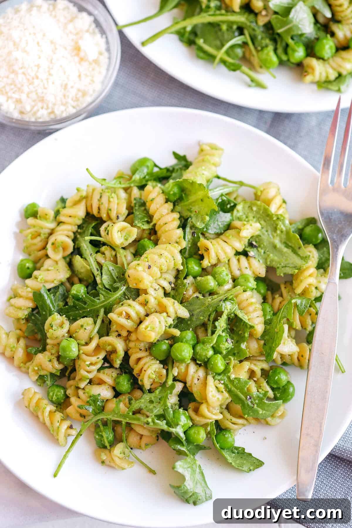 Light and fresh Pea and Arugula Pesto Pasta Salad on a plate