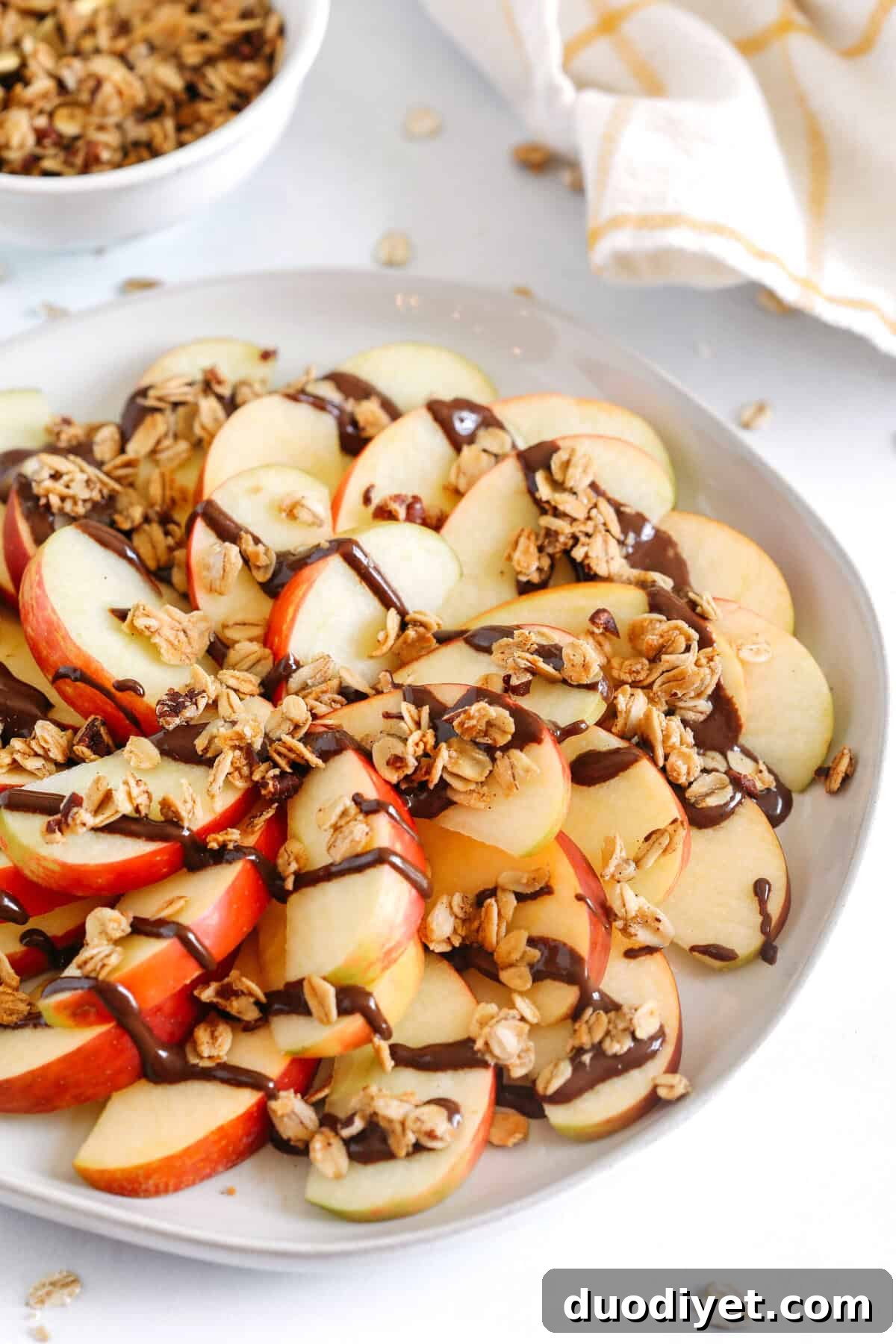 Chocolate-Dipped Apple Wedges with Granola Recipe 3 Chocolate and granola topped apple wedges on a platter