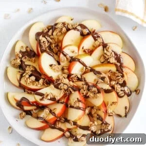 Delicious Chocolate Granola Apple Wedges easily made in just 10 minutes for the perfect after-school fall snack! Sliced apples layered with melted chocolate and sprinkled with homemade granola!