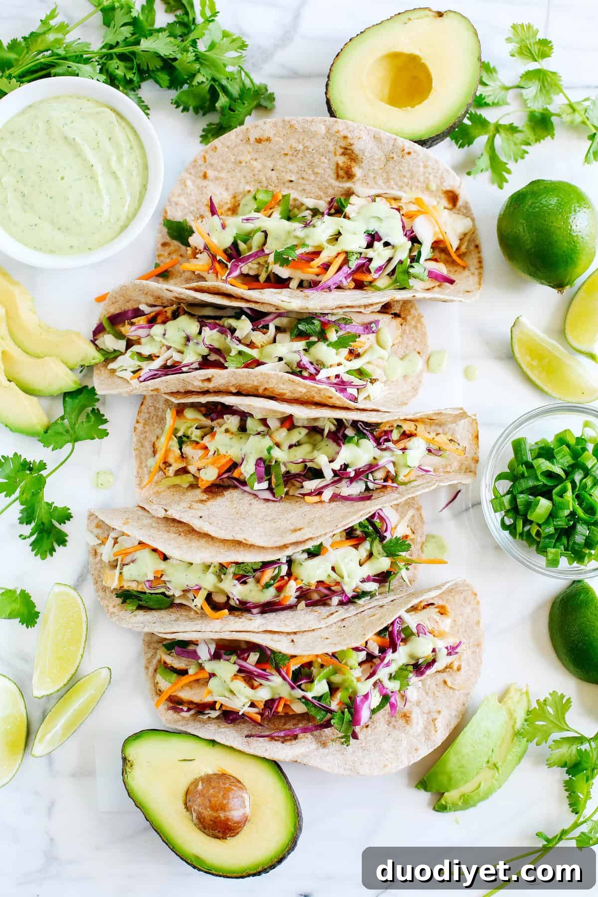 These Cilantro Lime Chicken Tacos with tangy coleslaw and avocado crema are simple, fresh and delicious making this the perfect EASY summer recipe!