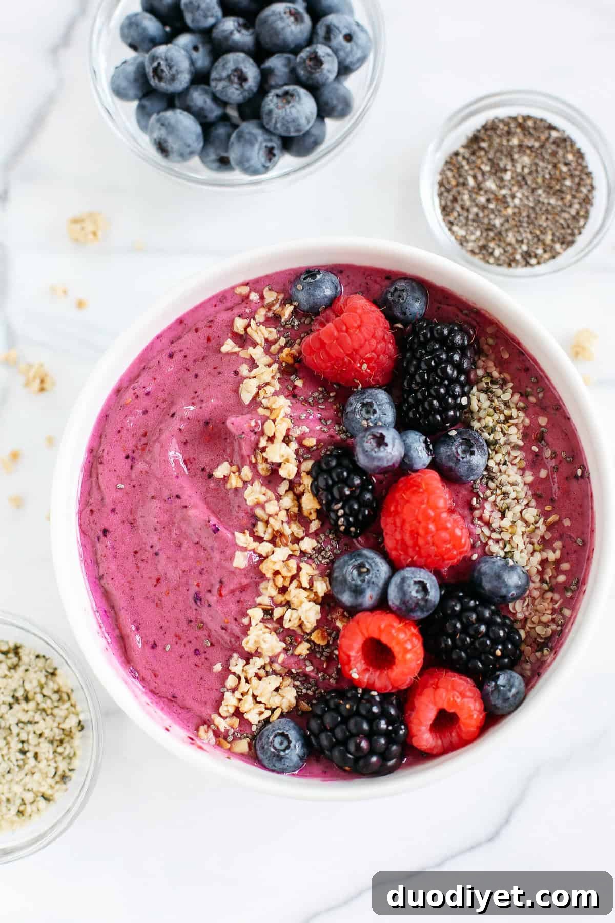This Triple Berry Smoothie Bowl is creamy, delicious and super EASY to make with a variety of fun toppings and fresh fruit!