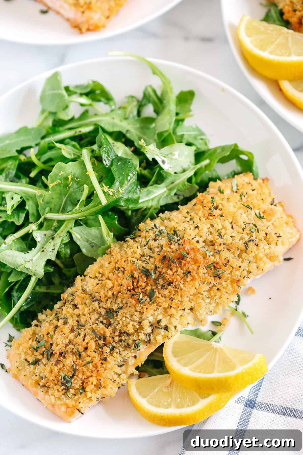 Hummus Crusted Salmon baked to perfection and served with a delicious Lemon Arugula Salad for the perfect healthy weeknight meal ready in under 30 minutes!