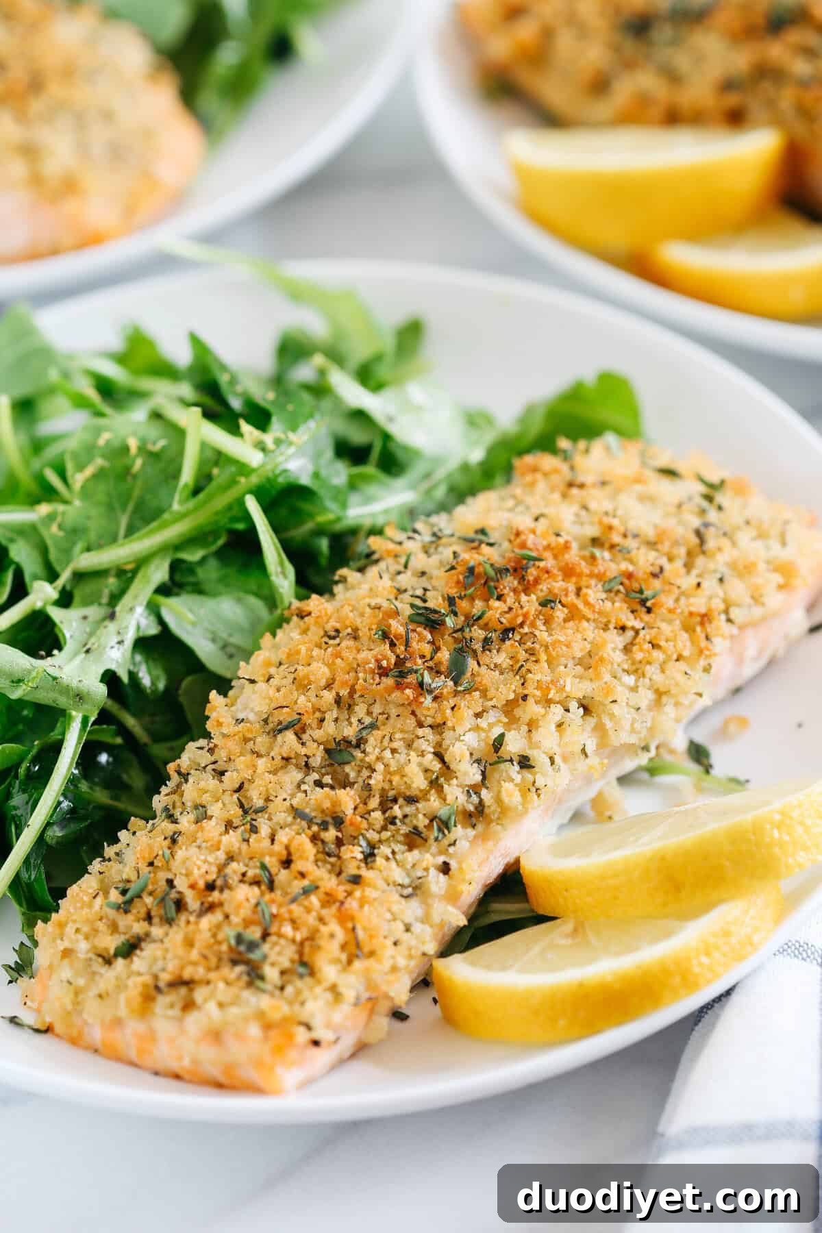 Hummus Crusted Salmon baked to perfection and served with a delicious Lemon Arugula Salad for the perfect healthy weeknight meal ready in under 30 minutes!