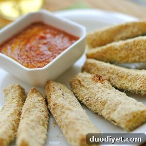 Small serving of baked zucchini sticks with marinara