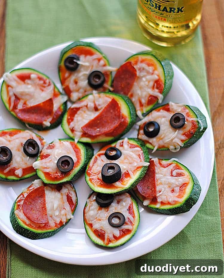 Mini Zucchini Pizza Bites Recipe 3 Close up of zucchini pizza slices with cheese and toppings