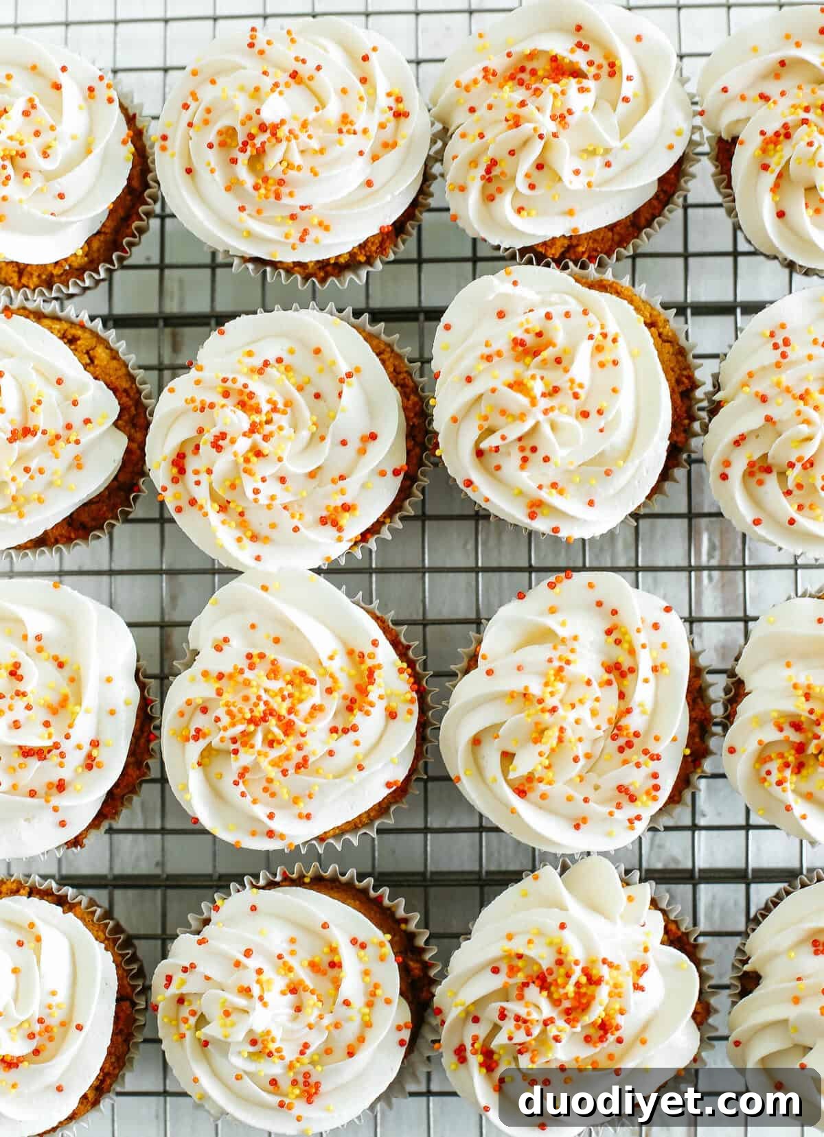 Plate of pumpkin spiced cupcakes with maple cream cheese frosting