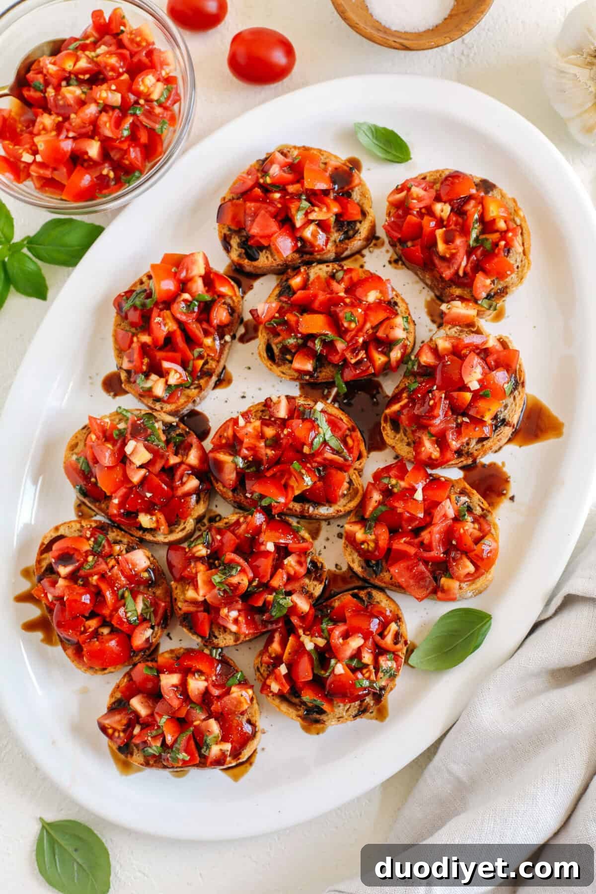 The Easiest Tomato and Basil Bruschetta recipe that is super flavorful, easy to make and such a huge crowdpleaser when entertaining! Made with fresh tomatoes, garlic cloves, rich balsamic vinegar, olive oil and fresh basil.
