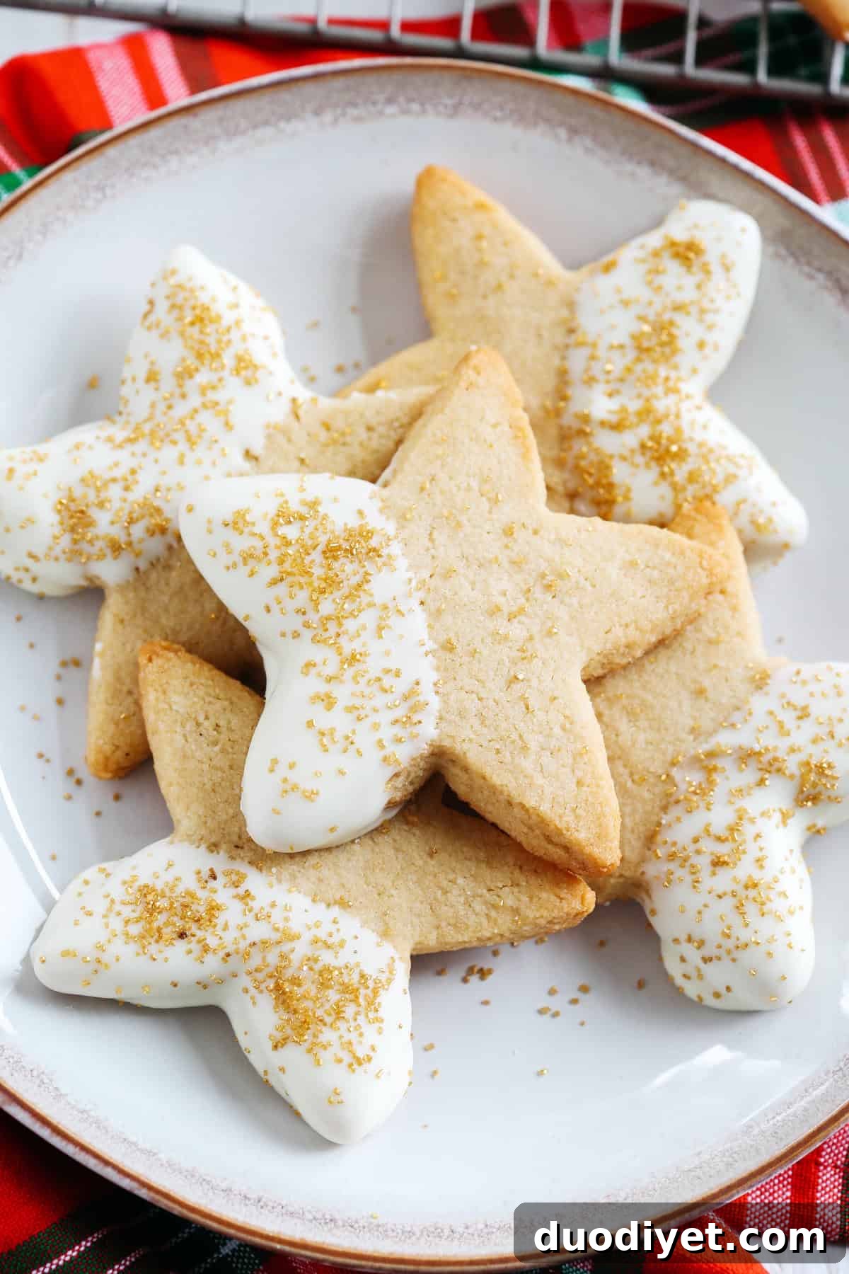 Grain-Free Holiday Sugar Cookies Recipe 2 Holiday grain-free sugar cookies on a wooden board
