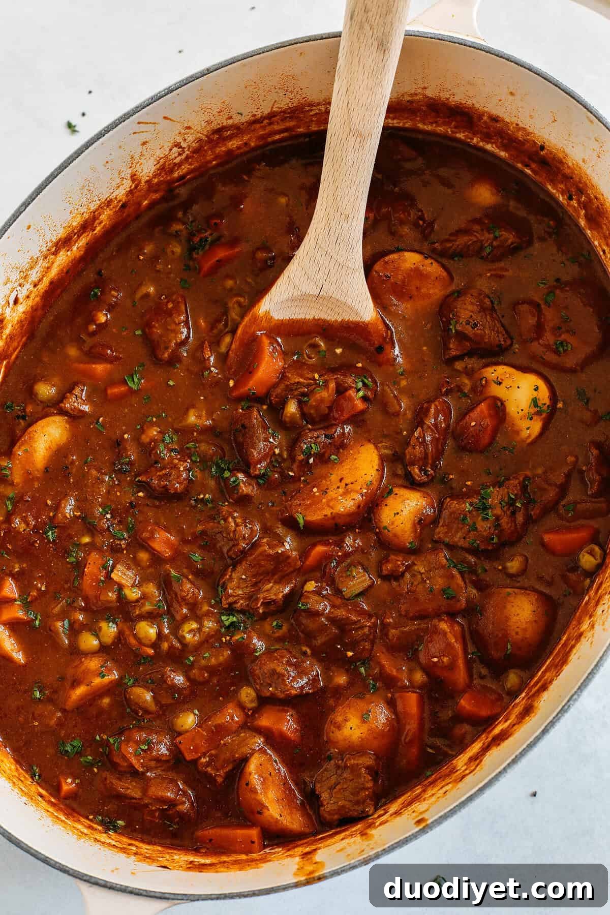 This classic hearty Beef and Tomato Stew is loaded with tender beef, melt in your mouth potatoes, veggies and fresh herbs!