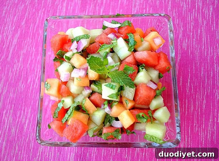 Bowl of Mojito Melon Salsa with herbs and lime