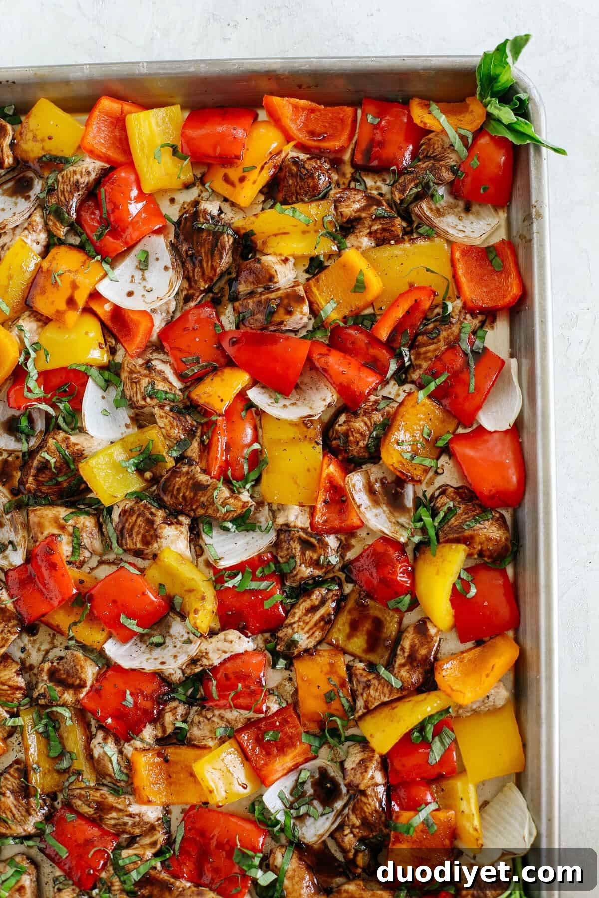 Honey Balsamic Sheet-Pan Chicken with Roasted Veggies 4 Baked chicken and vegetables on a sheet pan