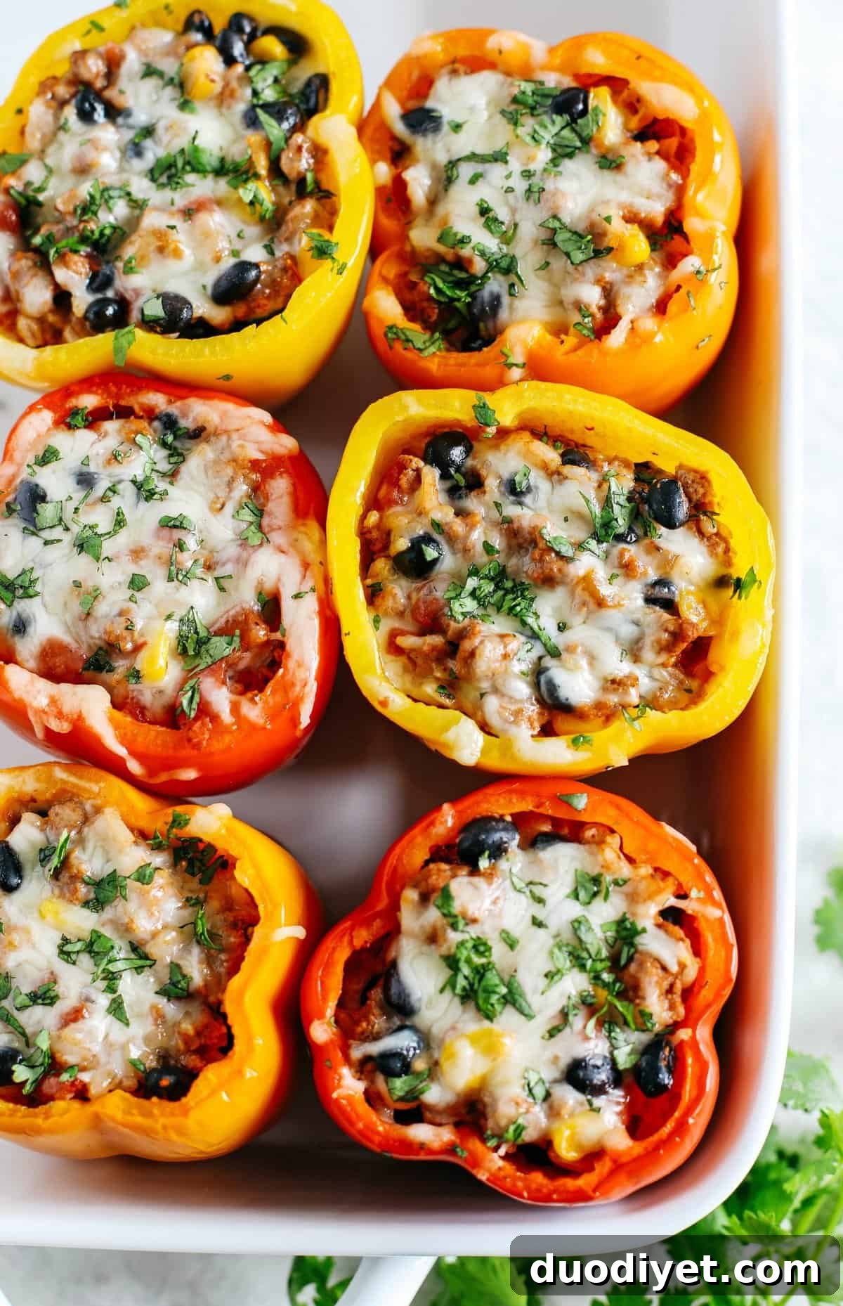 Light and healthy Mexican Stuffed Bell Peppers filled with seasoned ground turkey, brown rice, corn and black beans all topped with melted cheese!