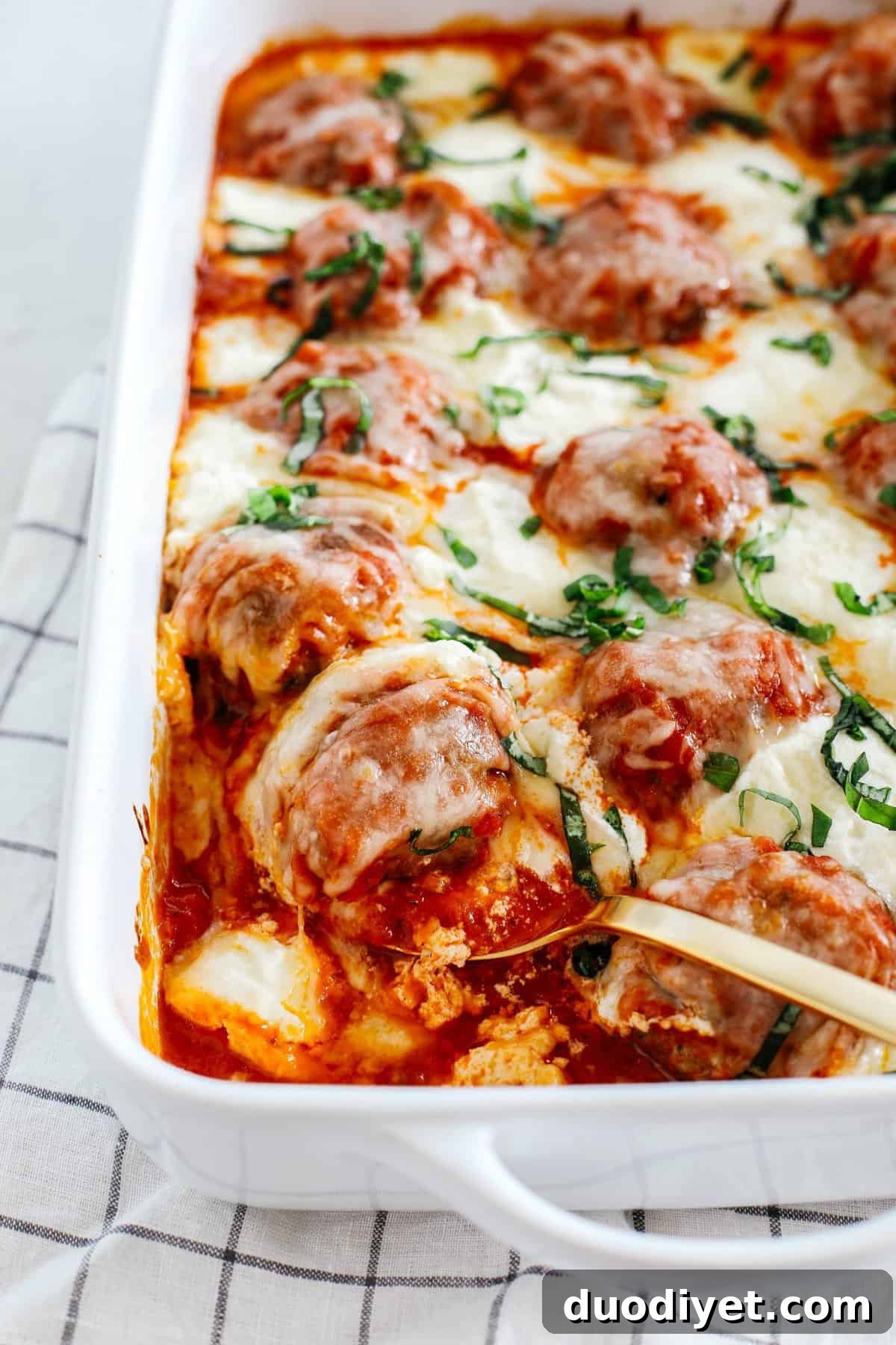 This Cheesy Keto Meatball Casserole is delicious and super filling! Made with homemade meatballs topped with creamy ricotta cheese, mozzarella and parmesan for the perfect low carb meal your whole family will enjoy!
