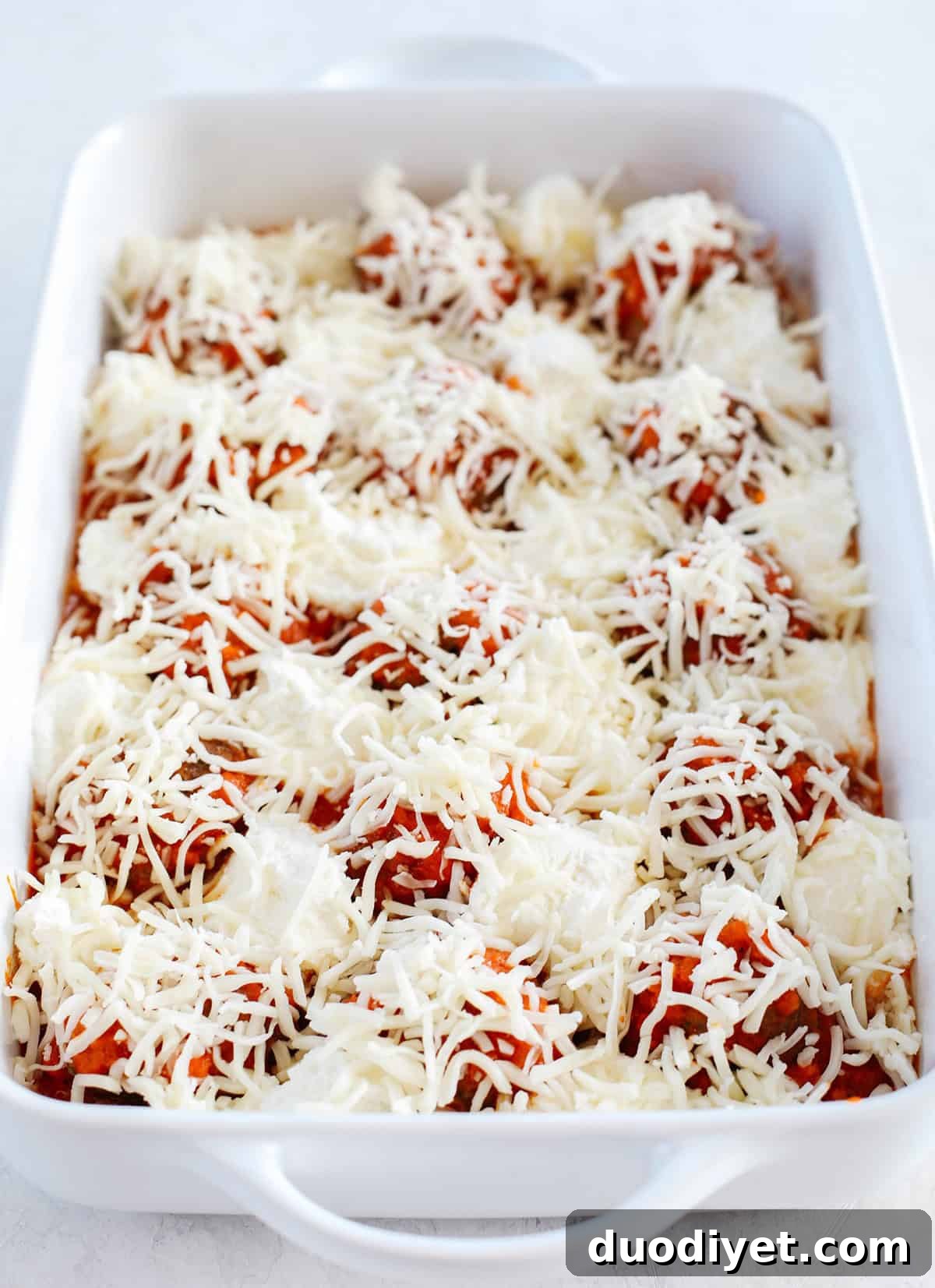 This Cheesy Keto Meatball Casserole is delicious and super filling! Made with homemade meatballs topped with creamy ricotta cheese, mozzarella and parmesan for the perfect low carb meal your whole family will enjoy!
