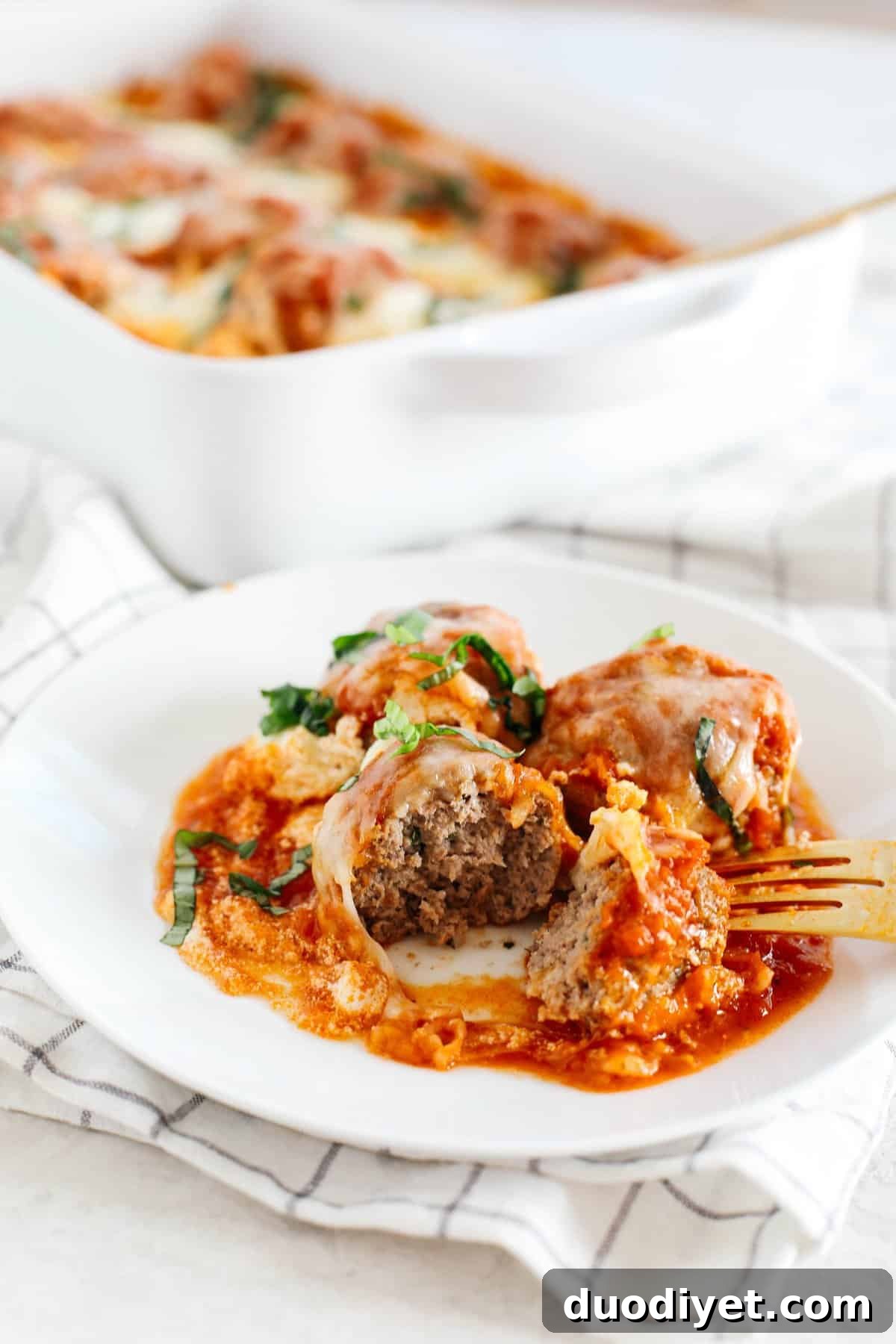 This Cheesy Keto Meatball Casserole is delicious and super filling! Made with homemade meatballs topped with creamy ricotta cheese, mozzarella and parmesan for the perfect low carb meal your whole family will enjoy!