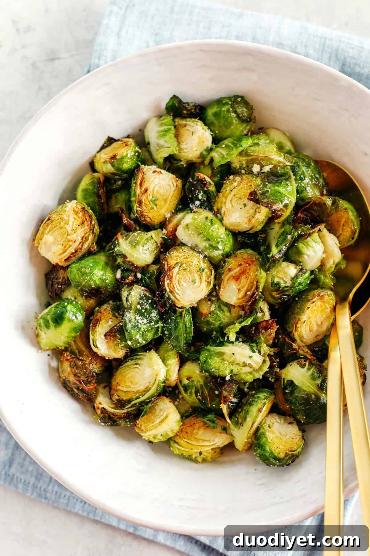 Crispy Garlic Parmesan Brussels Sprouts easily cooked in your air fryer in just 15 minutes for a delicious healthy snack or side dish!