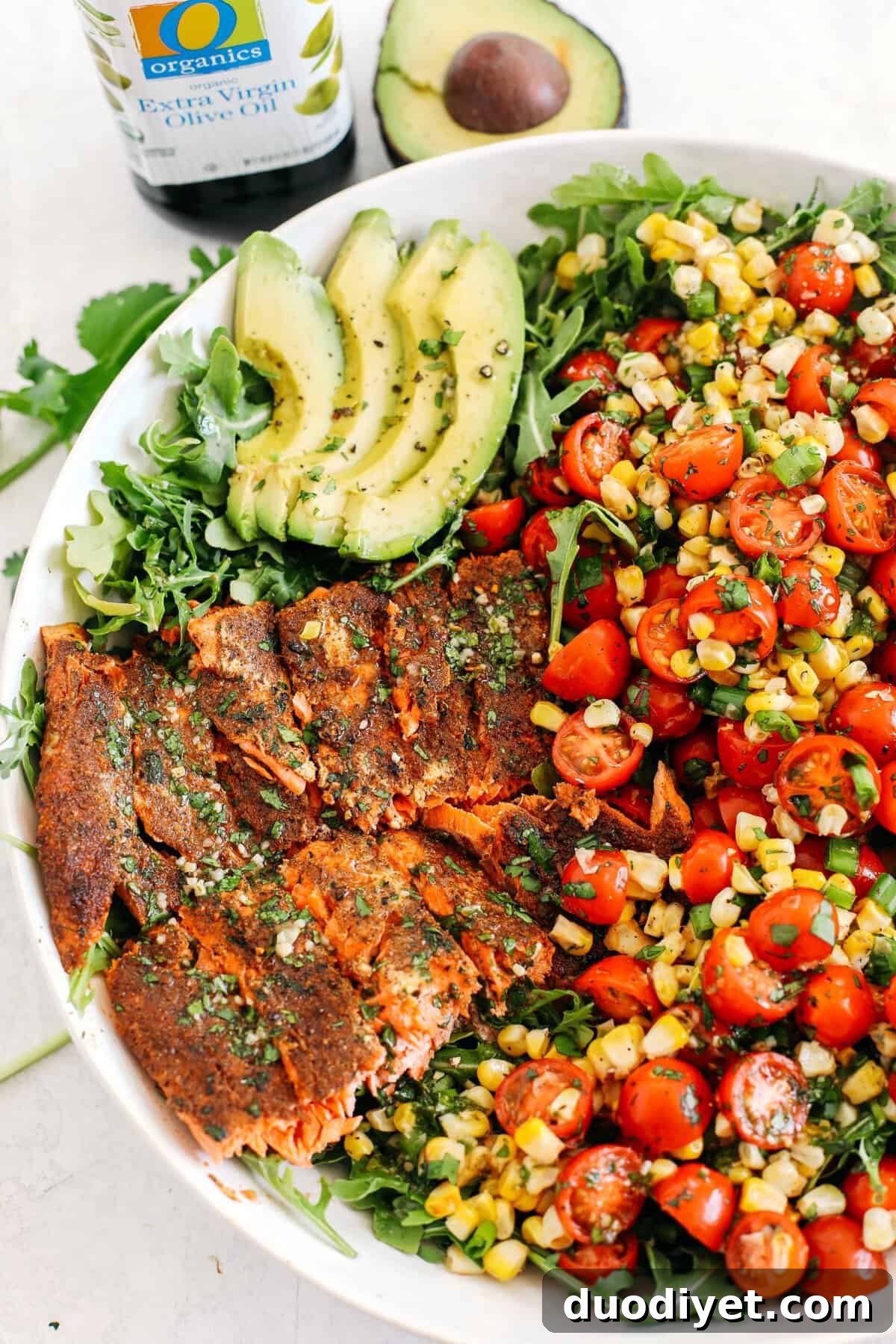 Chili-rubbed salmon with grilled corn, fresh tomatoes and sliced avocado