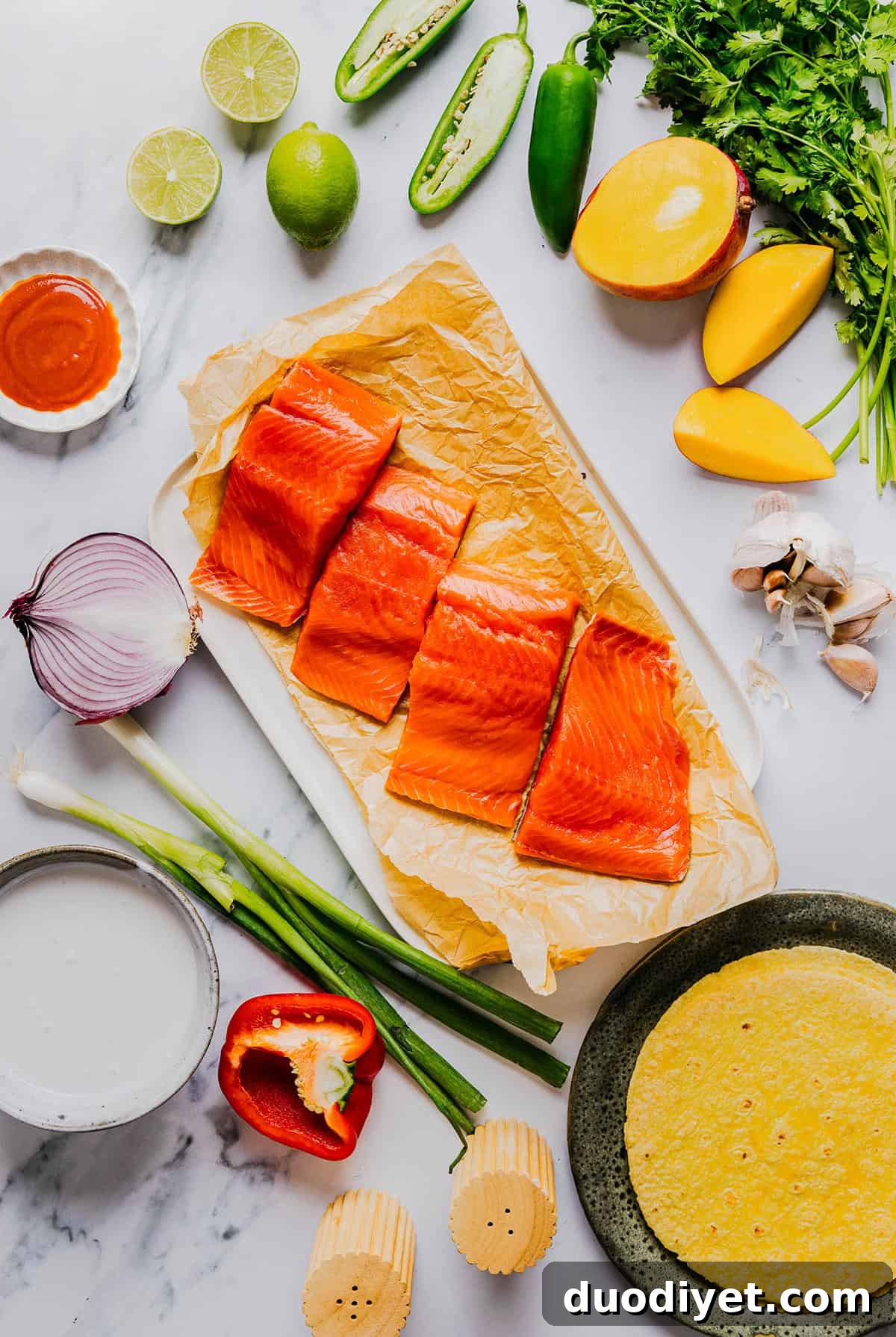 These Mango Sriracha Salmon Tacos make the perfect summer meal easily made in under 20 minutes!  These salmon tacos are simple, fresh and topped with the most delicious mango salsa!
