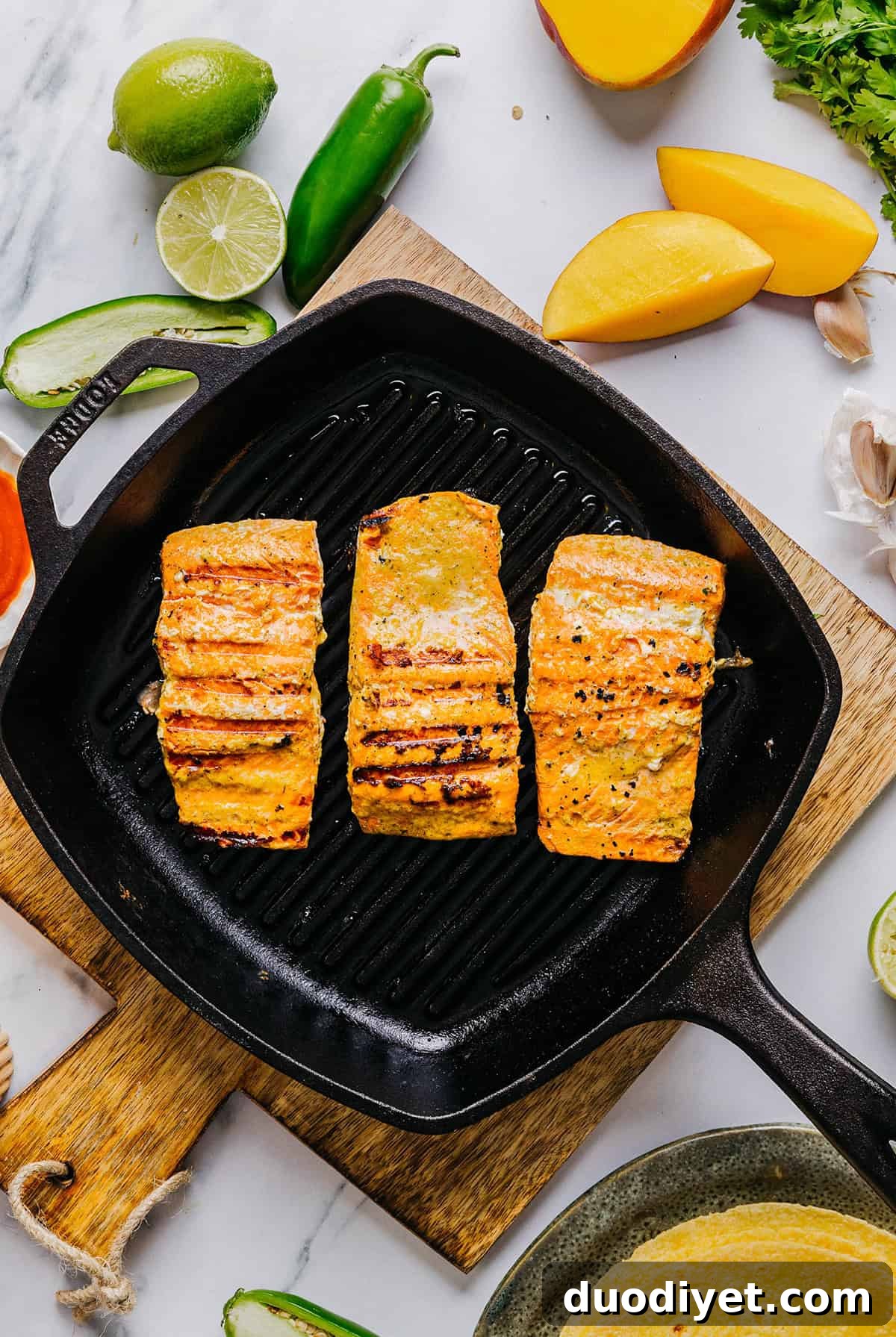 These Mango Sriracha Salmon Tacos make the perfect summer meal easily made in under 20 minutes!  These salmon tacos are simple, fresh and topped with the most delicious mango salsa!