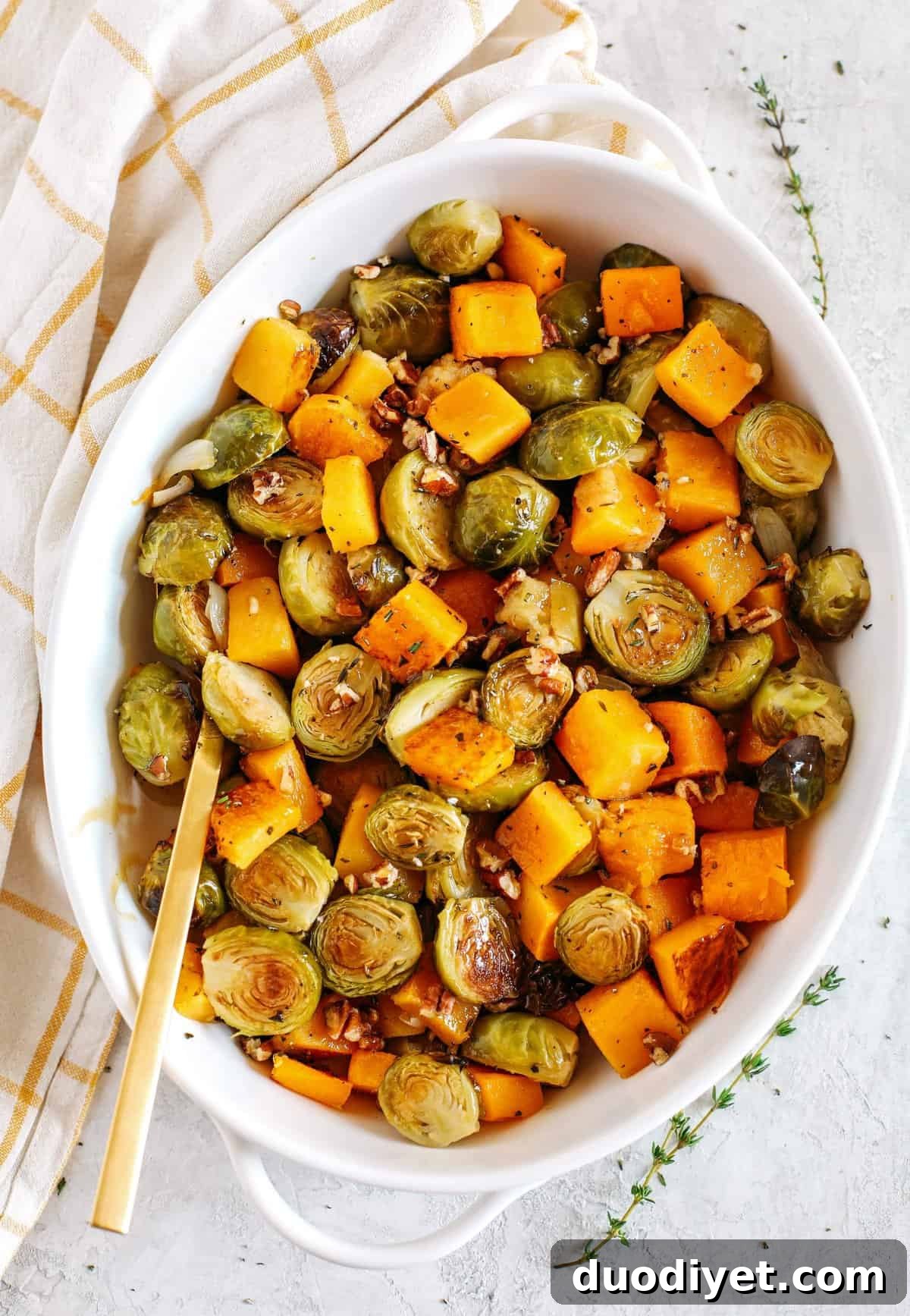 Maple-Glazed Butternut Squash and Brussels Sprouts Recipe 4 Roasted butternut squash, brussels sprouts and apples all tossed together with fresh herbs, chopped pecans and drizzled with a delicious maple dijon glaze! The perfect side dish to your holiday meal!