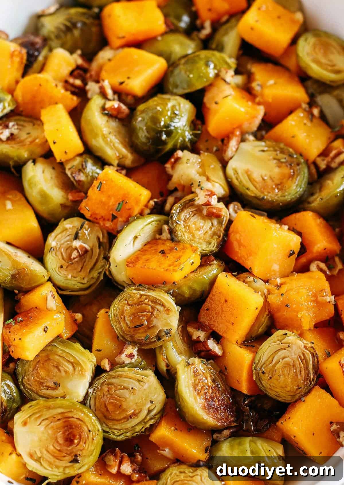 Roasted Maple-Glazed Butternut Squash and Brussels Sprouts 5 Roasted butternut squash, brussels sprouts and apples all tossed together with fresh herbs, chopped pecans and drizzled with a delicious maple dijon glaze! The perfect side dish to your holiday meal!