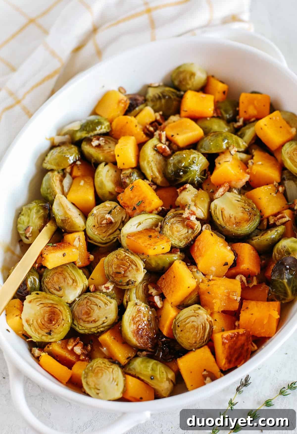 Maple-Glazed Butternut Squash and Brussels Sprouts Recipe 6 Roasted butternut squash, brussels sprouts and apples all tossed together with fresh herbs, chopped pecans and drizzled with a delicious maple dijon glaze! The perfect side dish to your holiday meal!