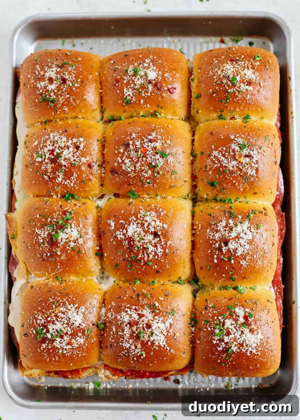 Spicy Italian Sliders Recipe for Party Sandwiches 2 Delicious Hot Italian Sliders perfect for game day that are layered with slices of ham, salami, pepperoni and provolone with a homemade roasted red pepper spread!
