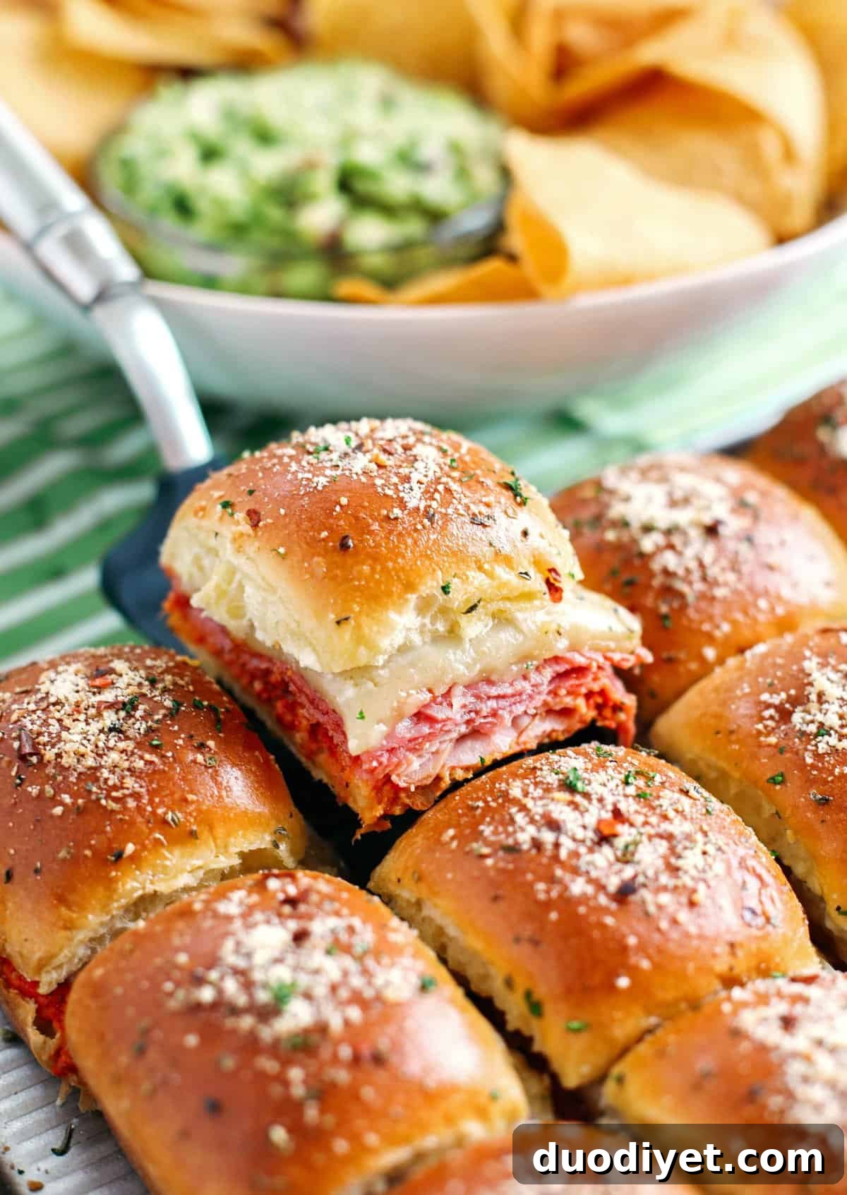 Hot Italian Sliders Recipe with Melted Provolone 4 Delicious Hot Italian Sliders perfect for game day that are layered with slices of ham, salami, pepperoni and provolone with a homemade roasted red pepper spread!