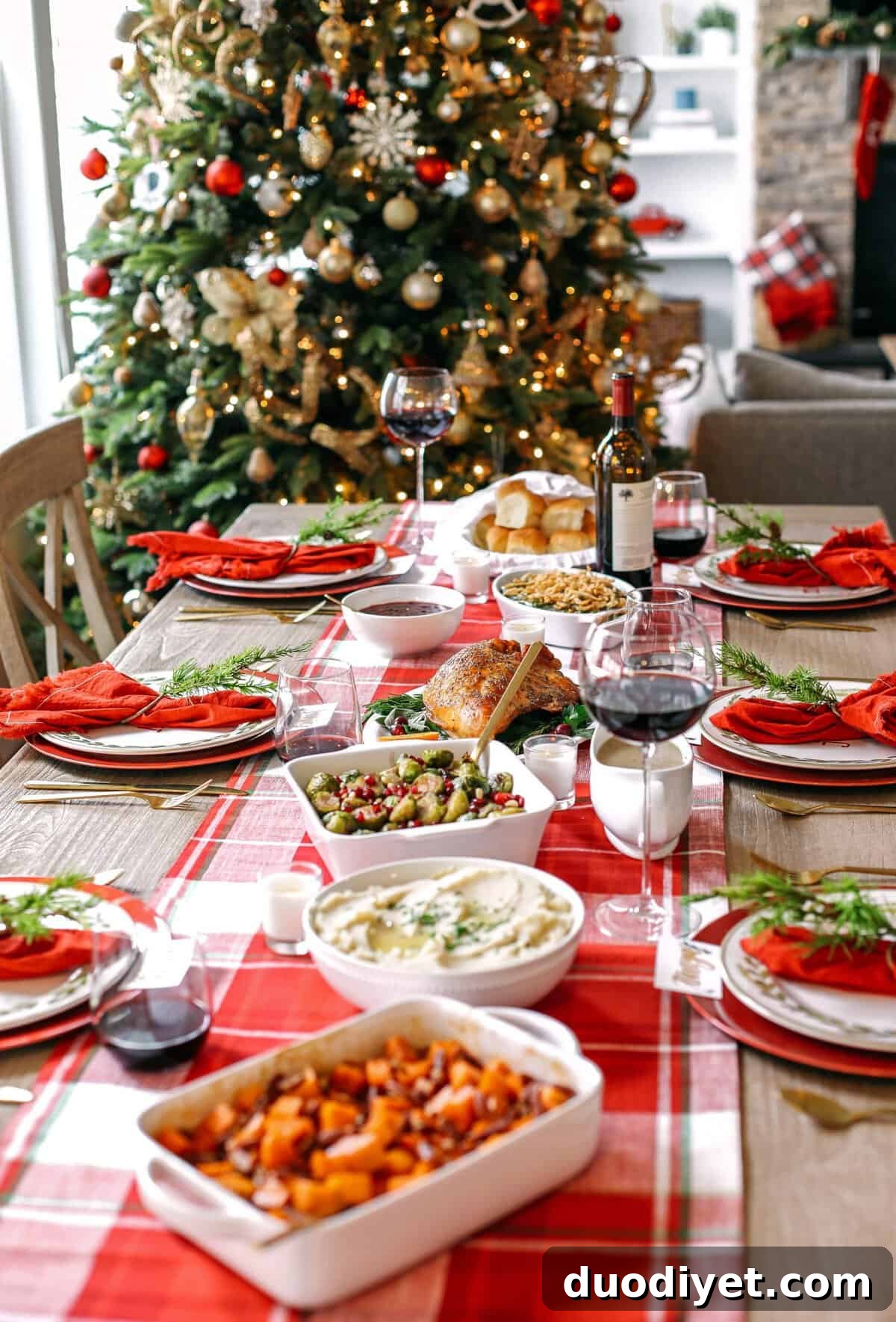 Cozy holiday table near a lit Christmas tree