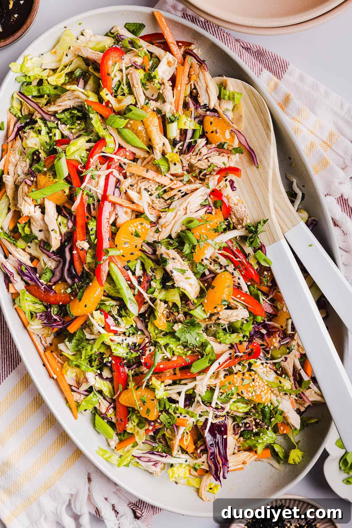 Chinese Chicken Salad with shredded chicken, napa cabbage, romaine, mandarin oranges, almonds, and ginger sesame dressing