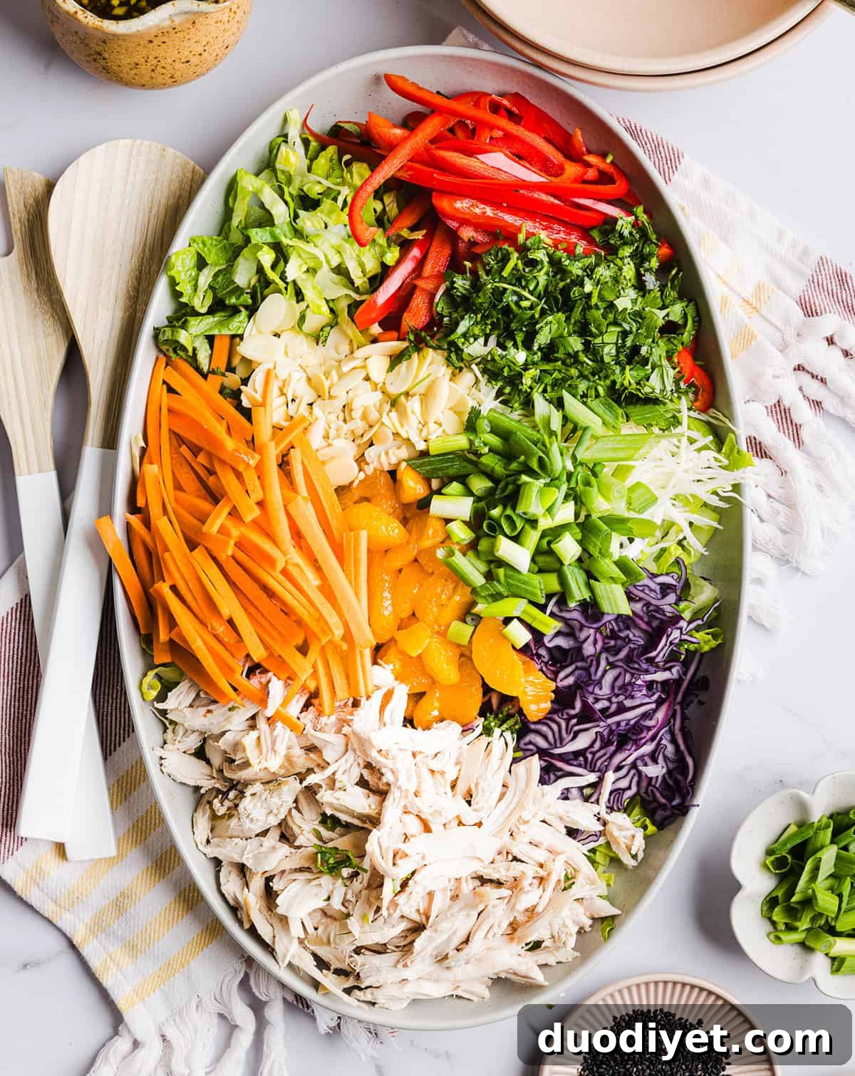 Salad bowl with ginger sesame dressing being poured
