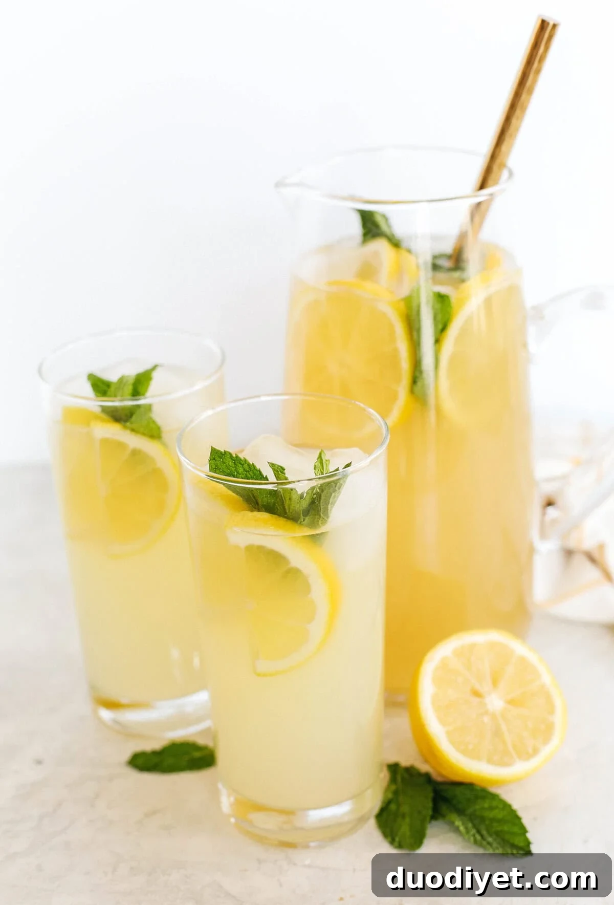 Homemade Honey Ginger Lemonade Recipe 4 Pitcher of honey ginger lemonade garnished with mint and lemon slices