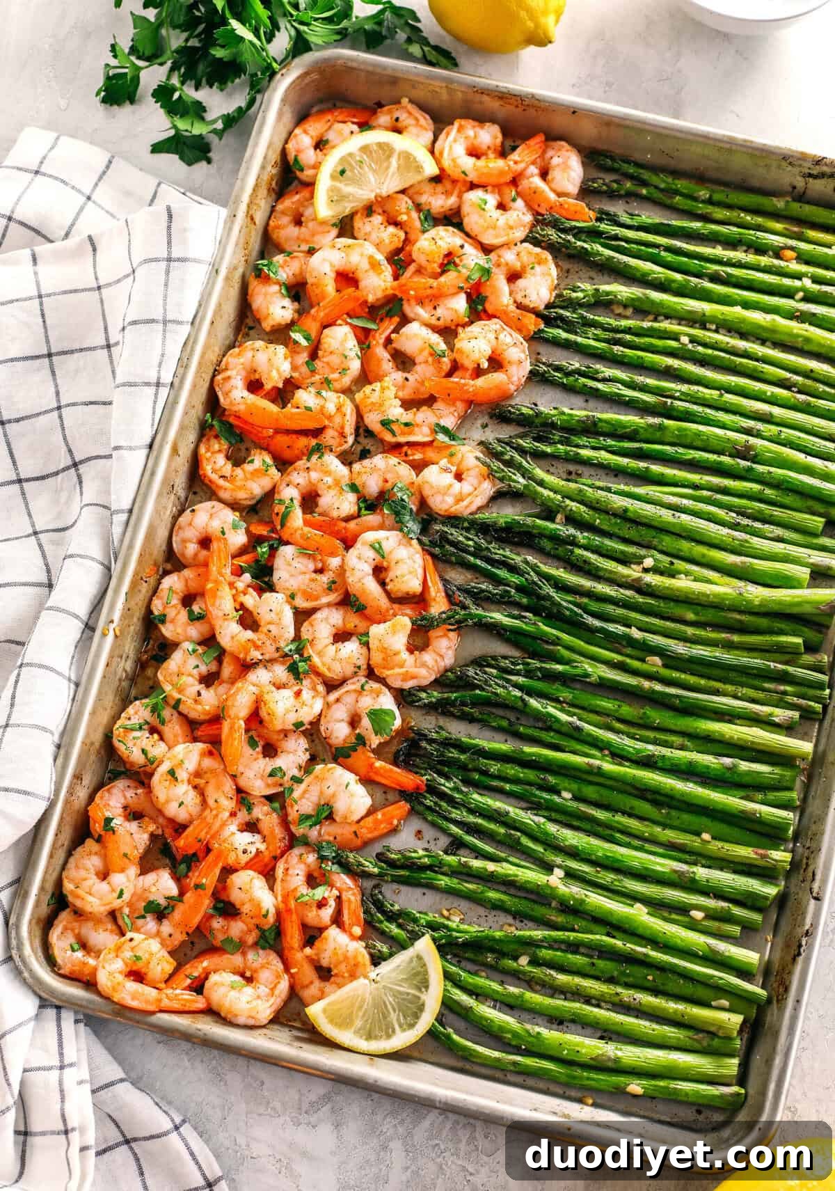 This Sheet Pan Lemon Garlic Shrimp and Asparagus is the perfect weeknight dinner loaded with flavor and easily made all in one pan in under 20 minutes!