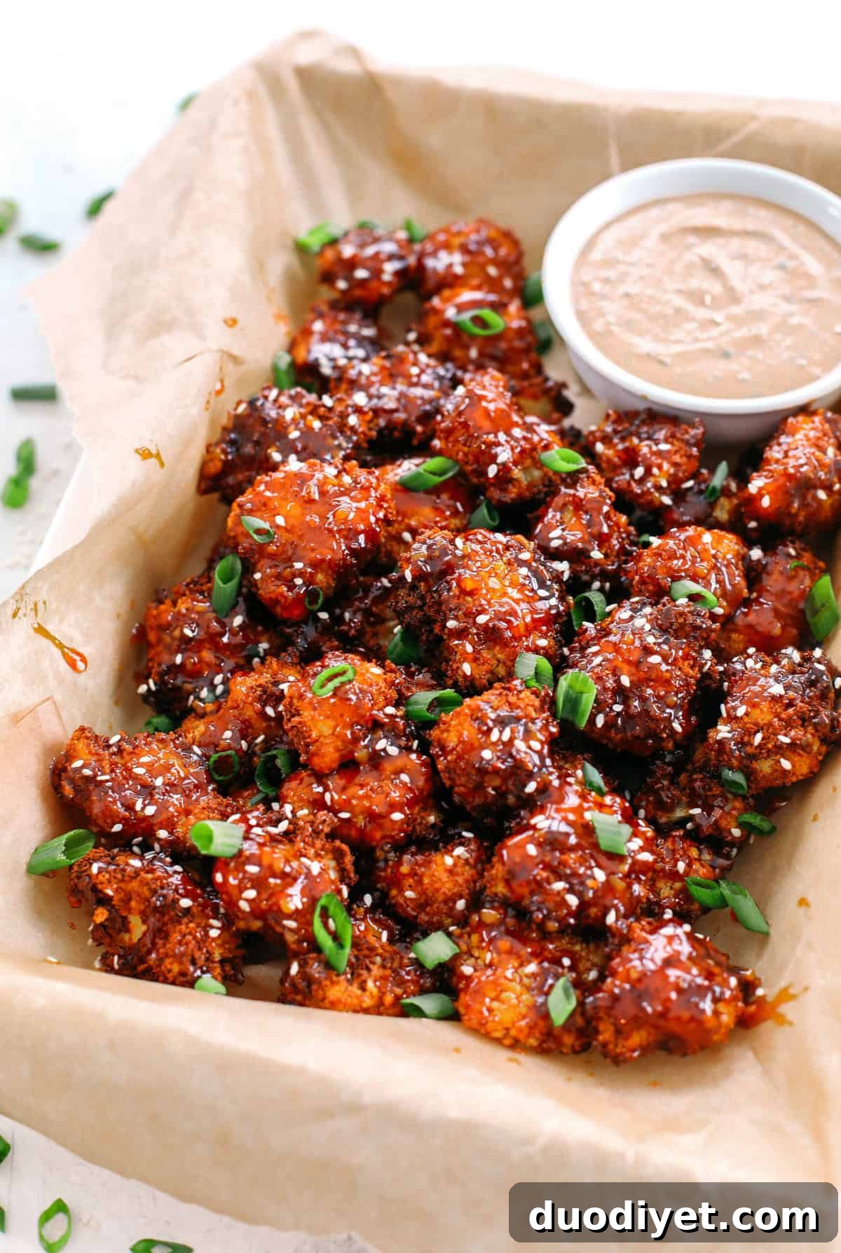 These Sticky Honey Garlic Cauliflower Wings are sweet, spicy and perfect for game day! Easily made in the air fryer and served with the most delicious spicy ranch dipping sauce!