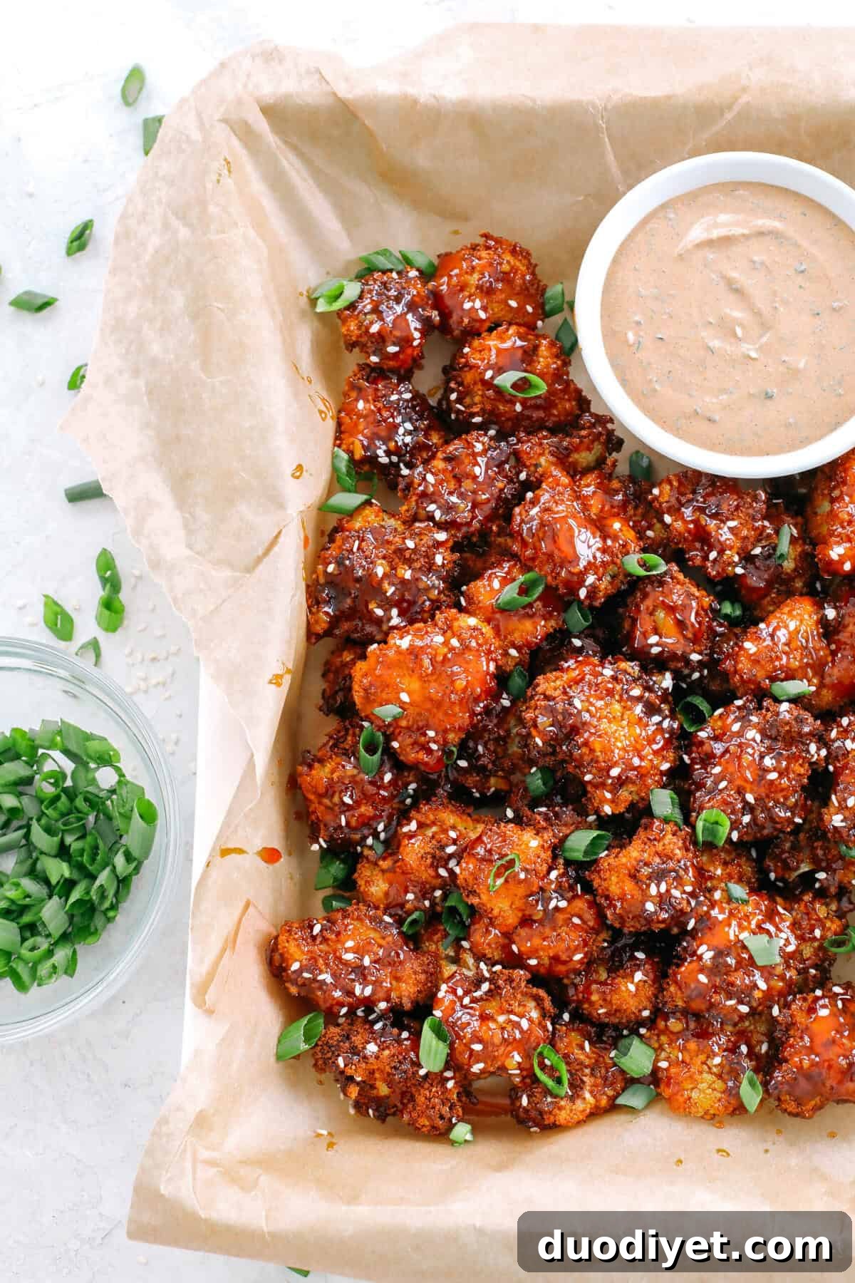 These Sticky Honey Garlic Cauliflower Wings are sweet, spicy and perfect for game day! Easily made in the air fryer and served with the most delicious spicy ranch dipping sauce!