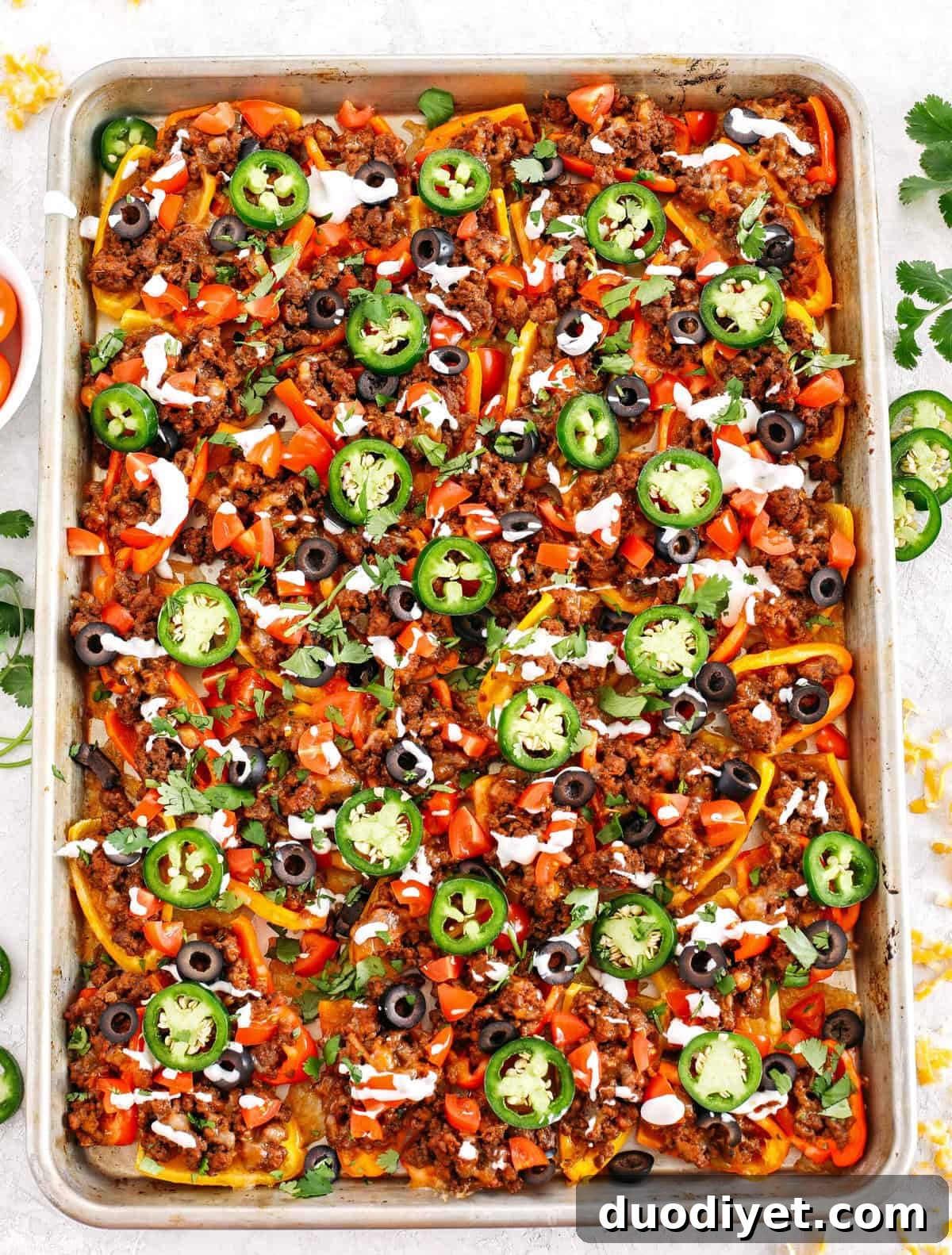 These Sheet Pan Loaded Bell Pepper Nachos are packed with all your favorite flavors and fun toppings making them the perfect low carb appetizer to enjoy on game day!